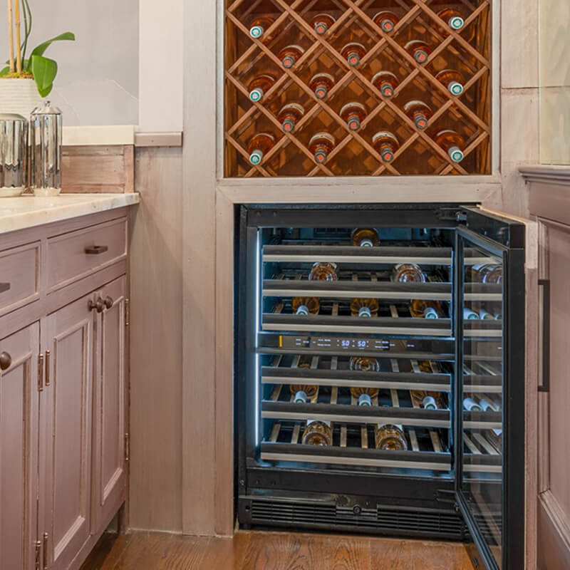 A home bar with a custom wine wall and an undercounter wine cellar.