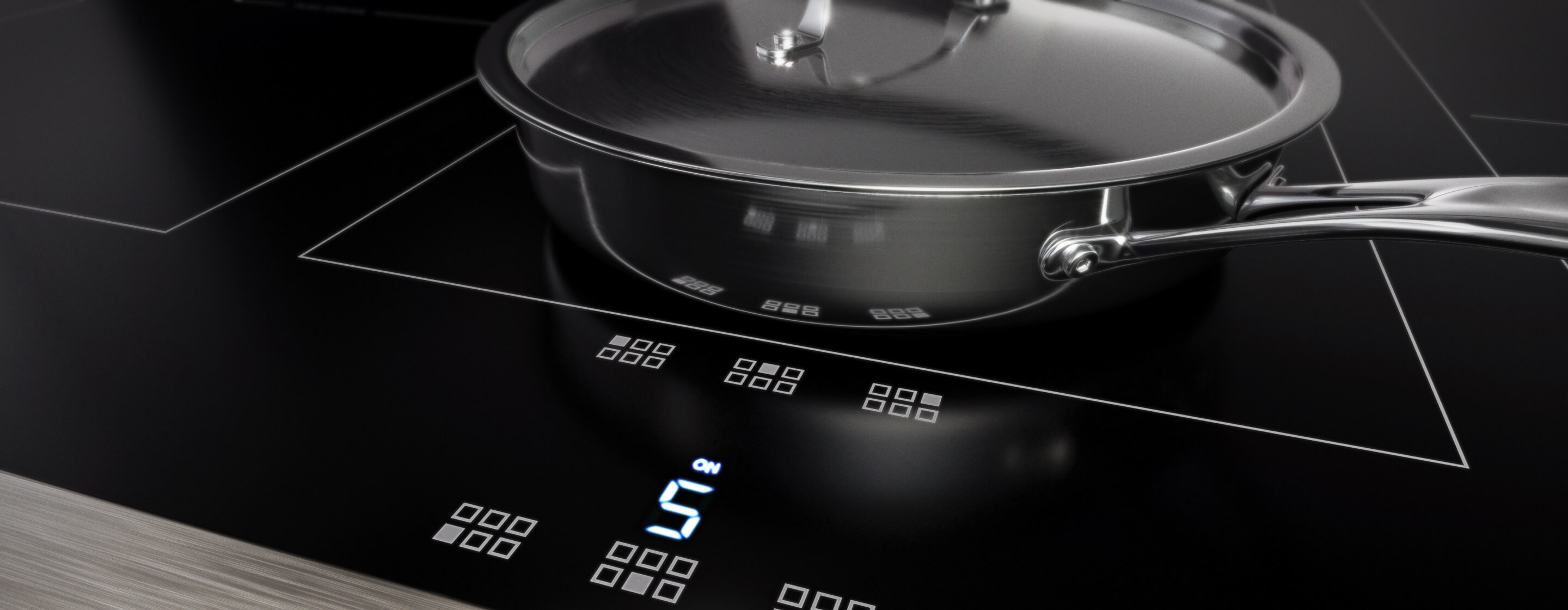 An induction cooktop with stainless steel cookware.