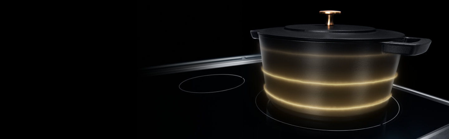 An induction-compatible cast-iron Dutch oven on an induction stovetop.