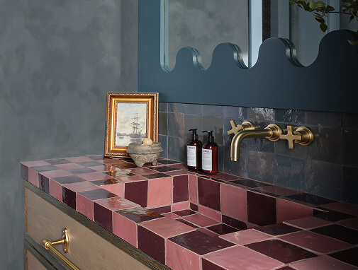 A bathroom with whimsical pink tile