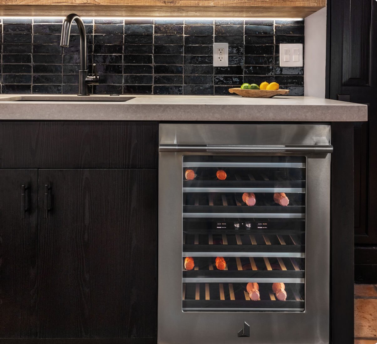 A close up of a JennAir® Undercounter Wine Cellar in a luxury kitchen.