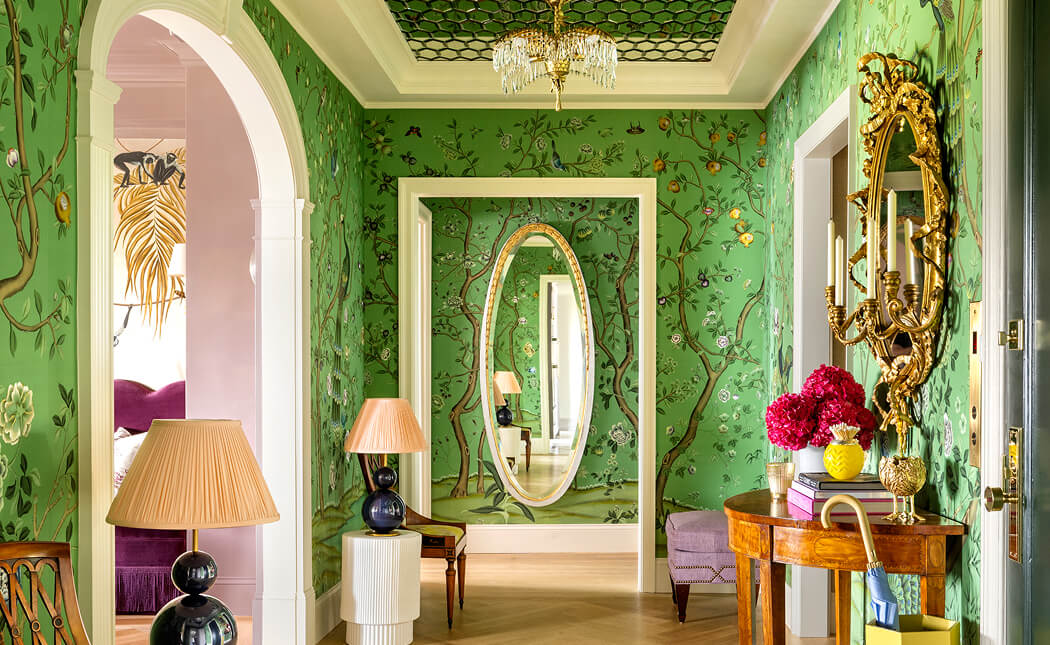 A green hallway with a floral wallpaper, designed by Corey Damen Jenkins.