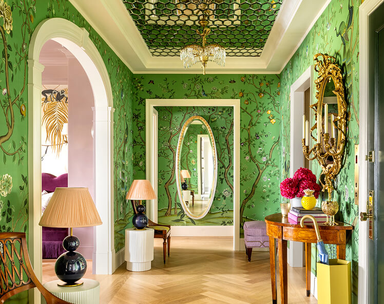 A green hallway with a floral wallpaper, designed by Corey Damen Jenkins.