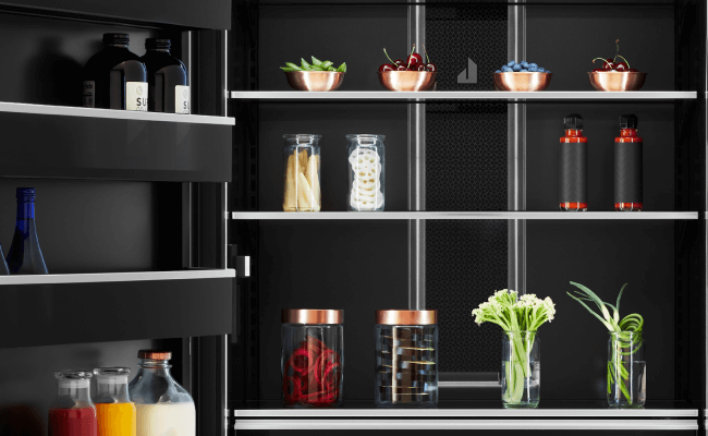 The interior of a JennAir Refrigerator filled with high-end foods and ingredients. 