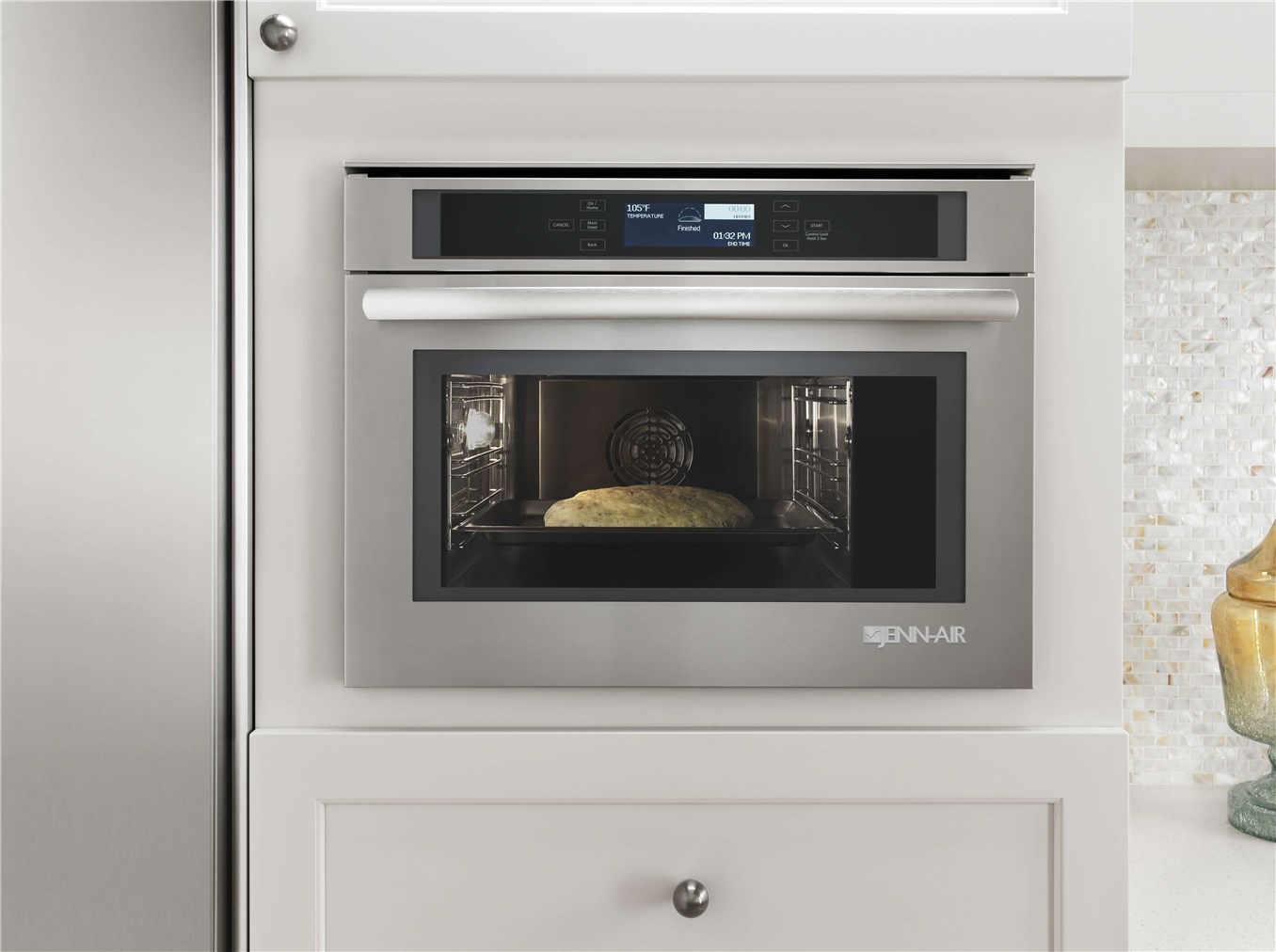 A wall oven inside of kitchen cabinets.