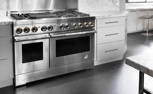 A JennAir Range in the RISE™ Design Expression in a bright white kitchen. 