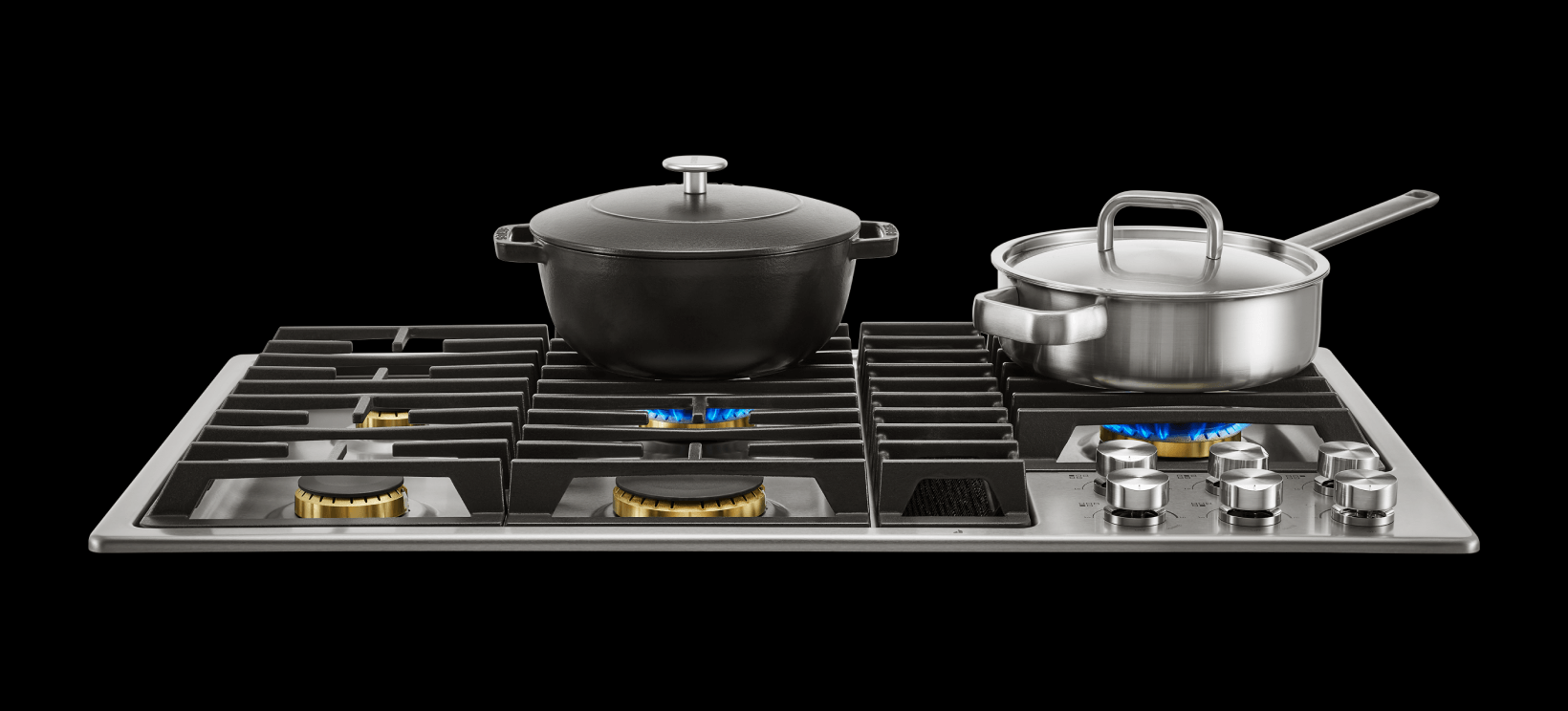 Two pots heating on a JennAir® gas cooktop