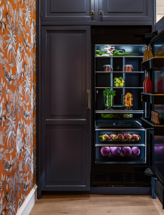 A pair of JennAir® Columns fitted with custom wooden panels.