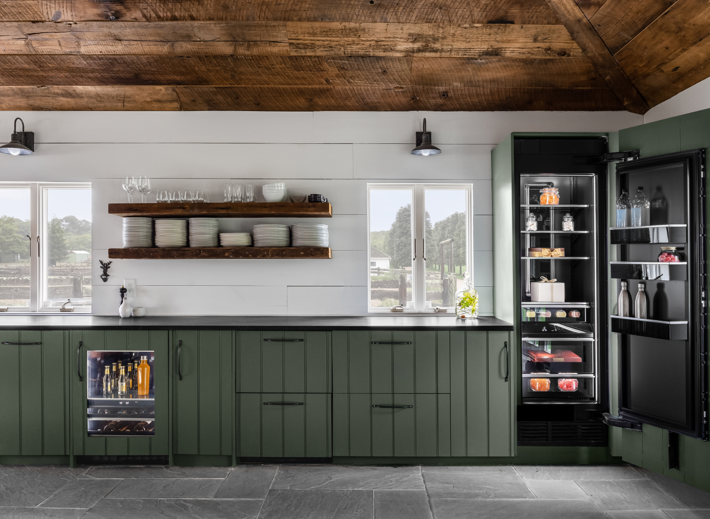 A view of the main bank of cabinets, featuring a panel-ready beverage center and a column refrigerator.