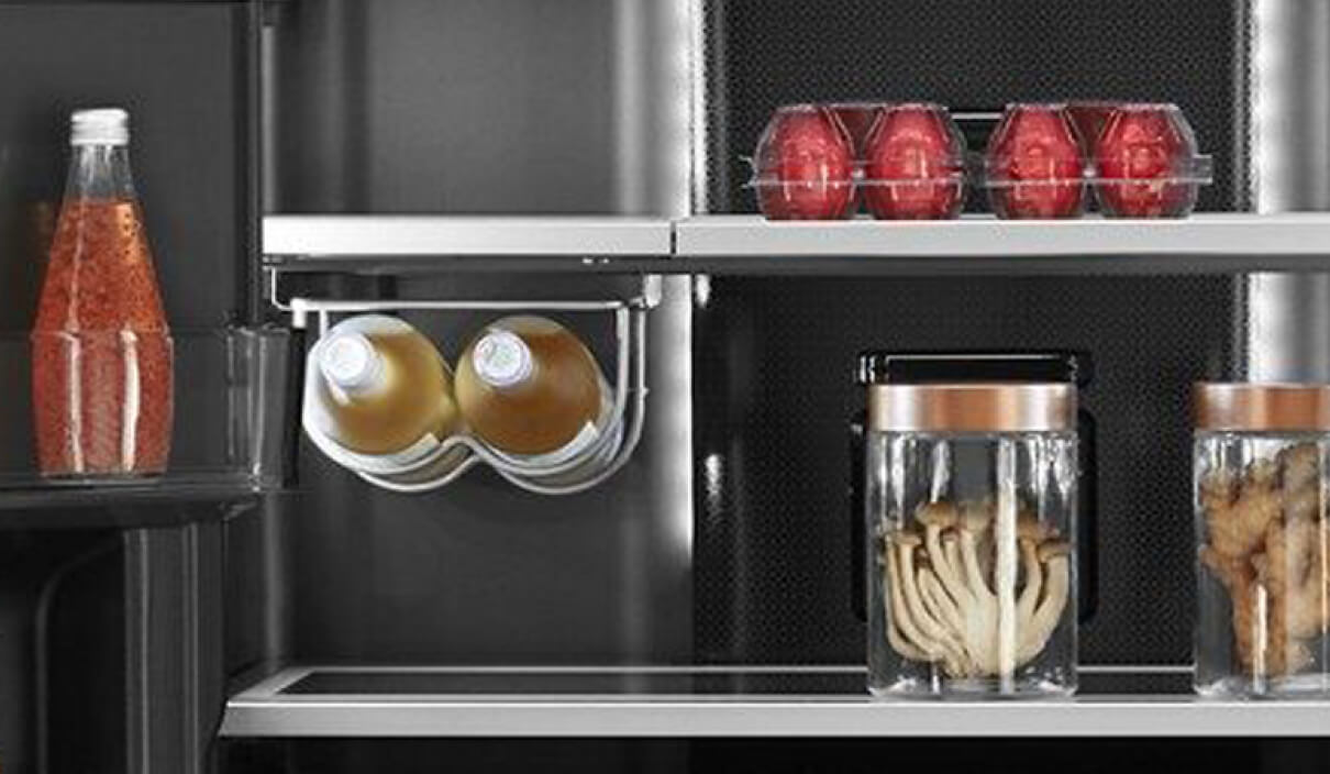 Two bottles of wine stored in the integrated glass undershelf wine bottle rack. 
