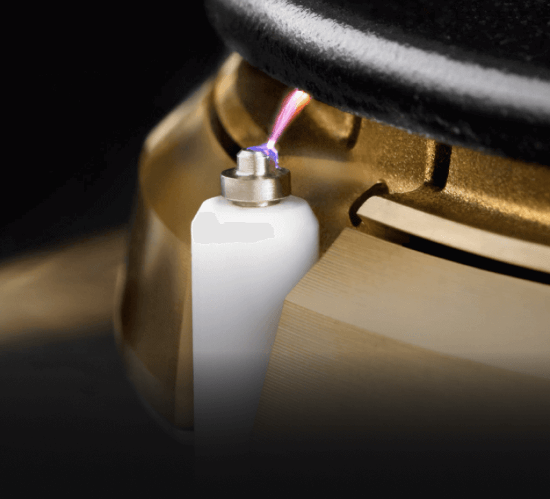 A close up of the lighting mechanism of a burner.