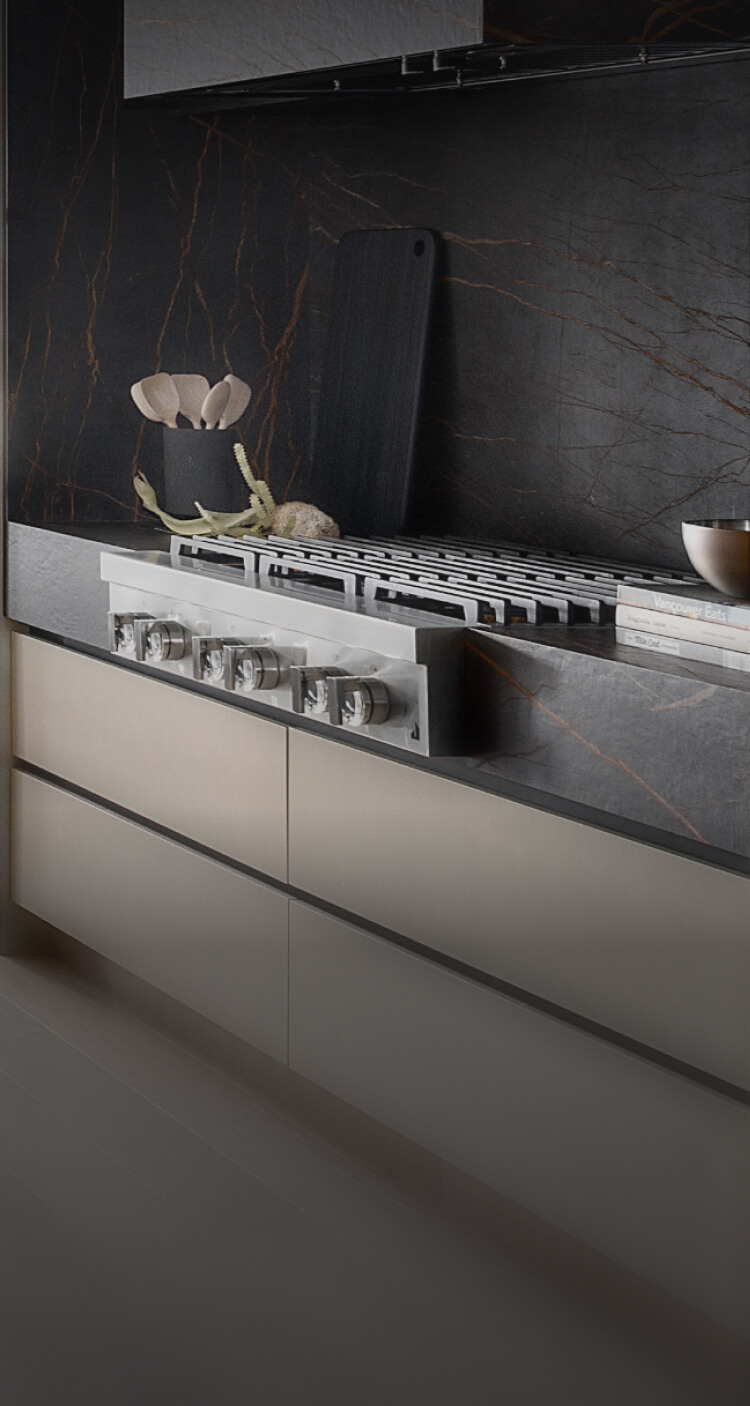 A JennAir® Gas Rangetop in a light-colored kitchen with dark accents.