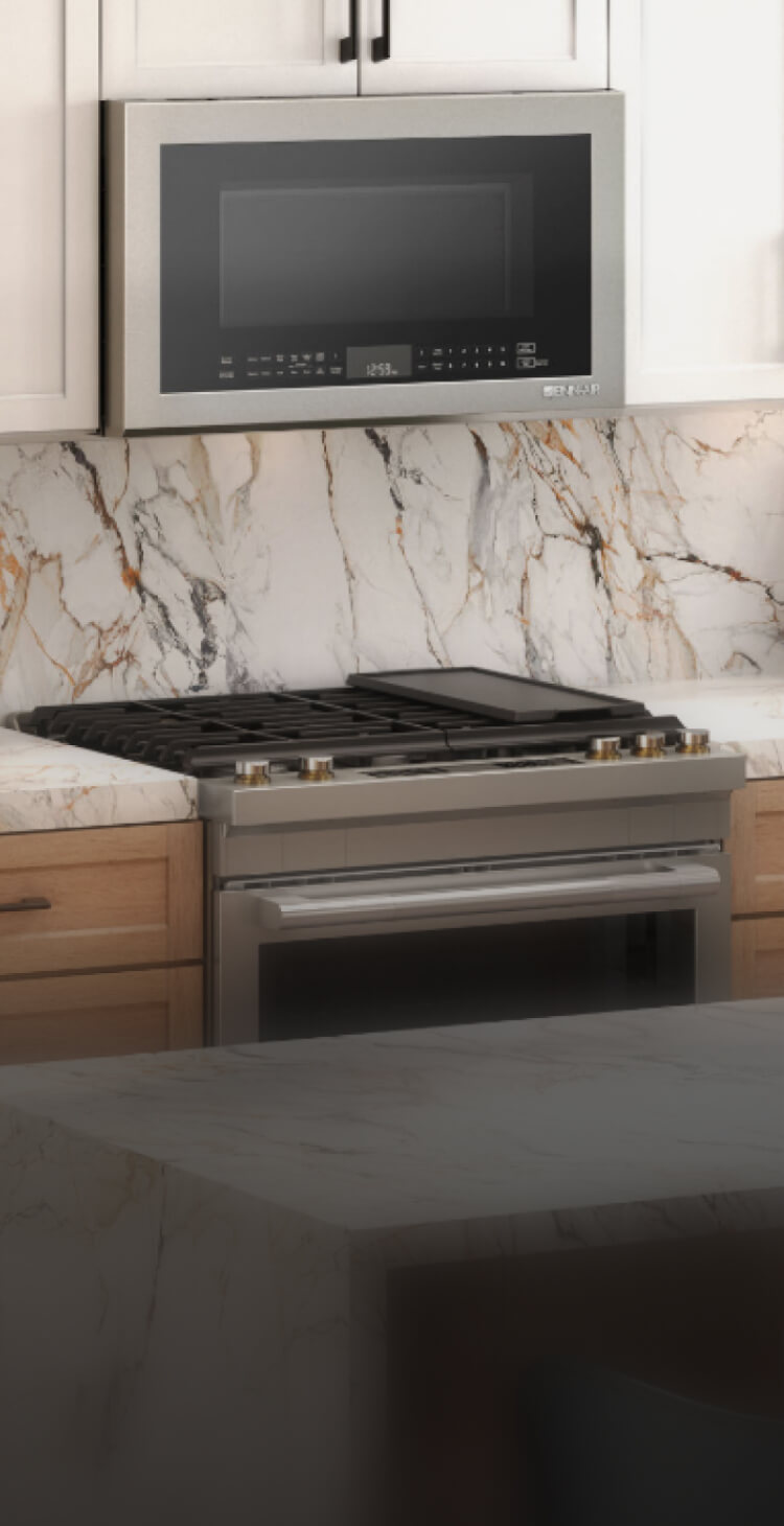 A JennAir® RISE™ Slide-In Range in a high-end kitchen.