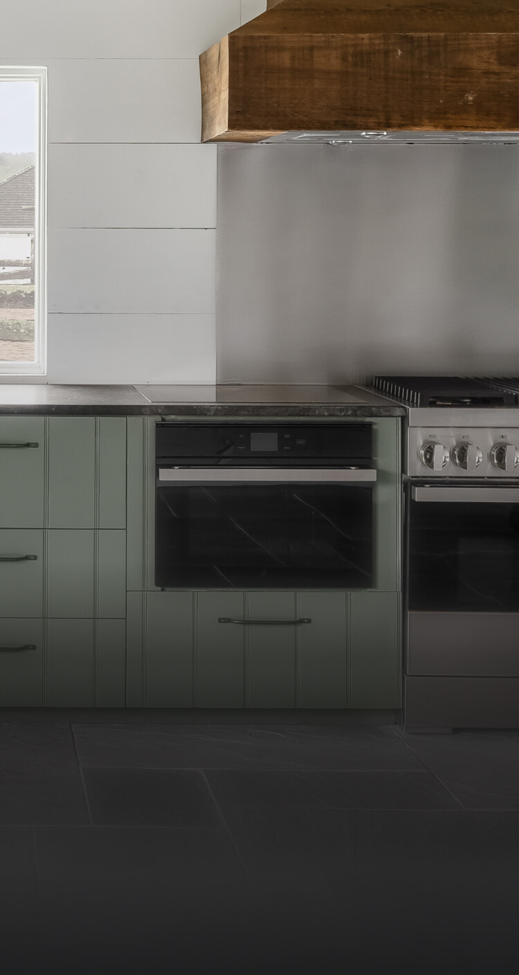 A JennAir® NOIR™ Dual-Fuel Range and Steam Oven in a high-end kitchen.