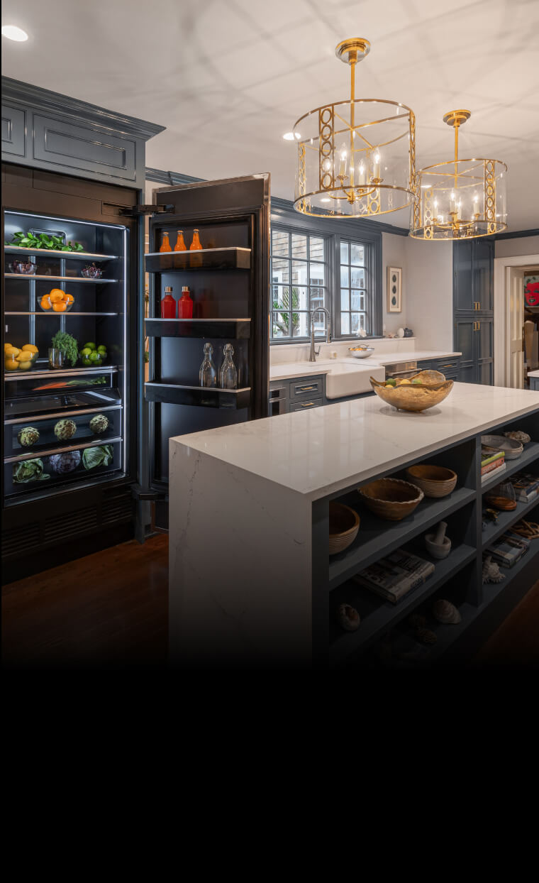 A beautiful blue kitchen with JennAir® appliances.