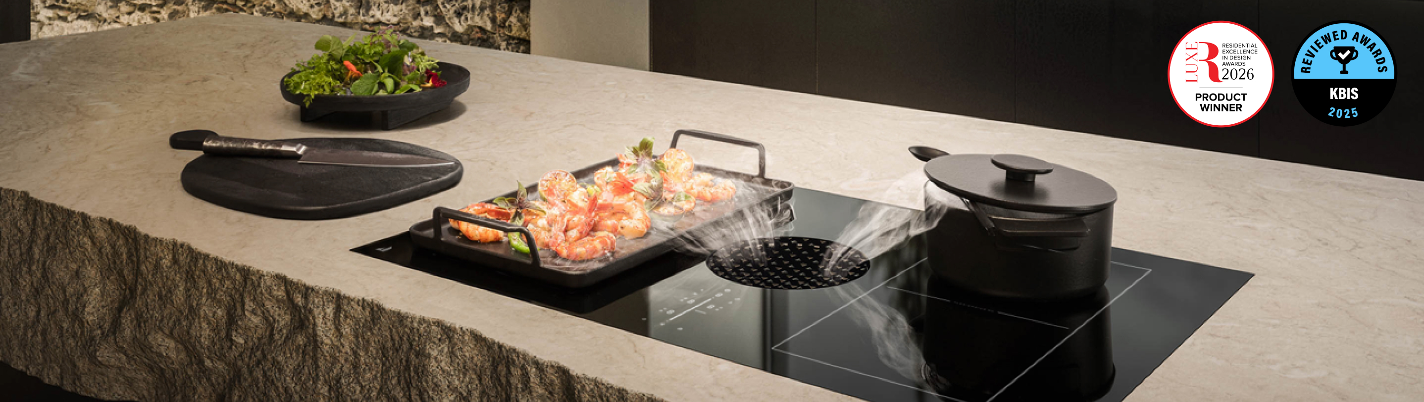 Two dishes with steam cooking on a JennAir® Induction Downdraft Cooktop.