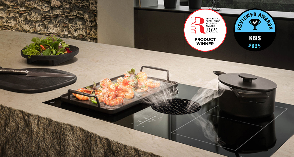 Two dishes with steam cooking on a JennAir® Induction Downdraft Cooktop.