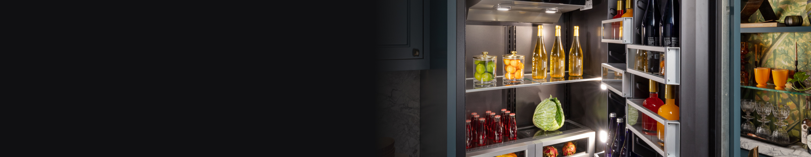 A mint-colored JennAir® Panel-Ready Refrigerator next to matching cabinets
