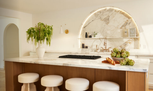  A white and light wood kitchen with a marble backsplash, designed by Nina Takesh.