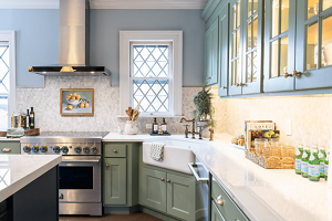 A JennAir® range and range hood installed in the bright kitchen