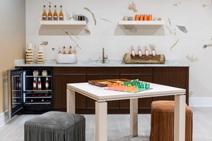 An open JennAir® Undercounter Refrigerator installed in a wet bar