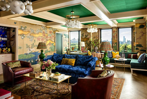 A living room filled with color, texture and pattern, including a coffered ceiling.