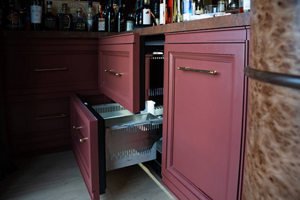 A JennAir® Refrigerator and Freezer Drawer outfitted with maroon custom cabinetry
