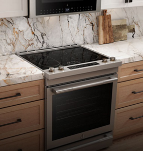 An induction slide-in range in a white and wood kitchen.