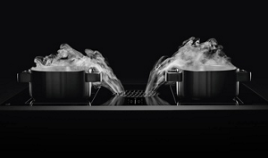 Two pans with the steam being pulled into the center vent.