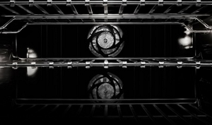 The interior of the wall oven, showing the dual convection fans and the flat tine racks.