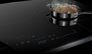 A pan steaming on an induction cooktop.